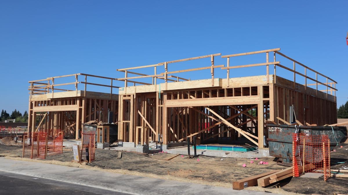 A mixed-use commercial building under timber-frame construction on a clear day.